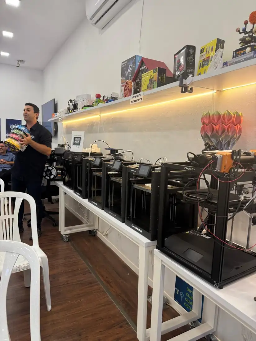 שורה של מדפסות תלת־ממד על משטח עבודה